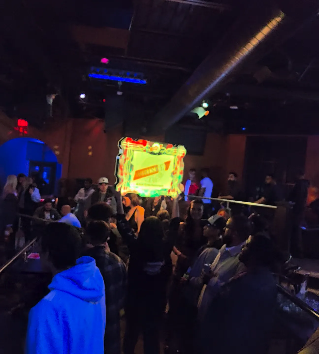Guests gathered around the Whiskey club floor during a bottle-service celebration.