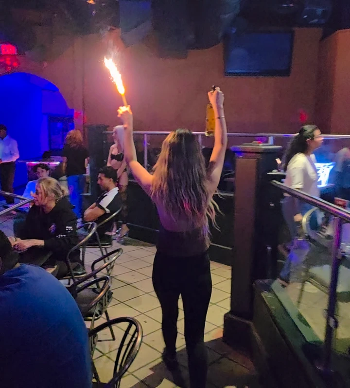 The Whiskey team passes tables during a bottle-service celebration