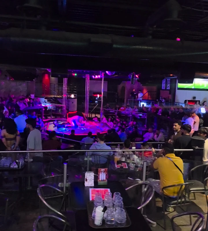 Glassware and tables overlooking a night inside Whiskey A Go-Go