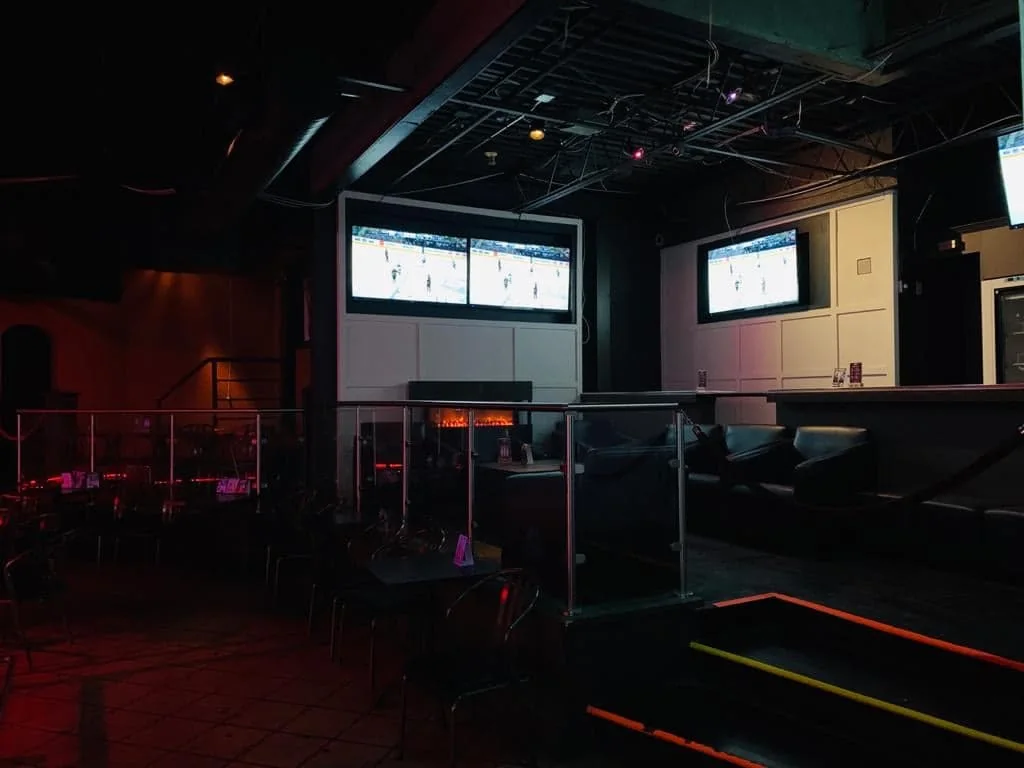 Raised lounge seating and televisions inside Whiskey A Go-Go.